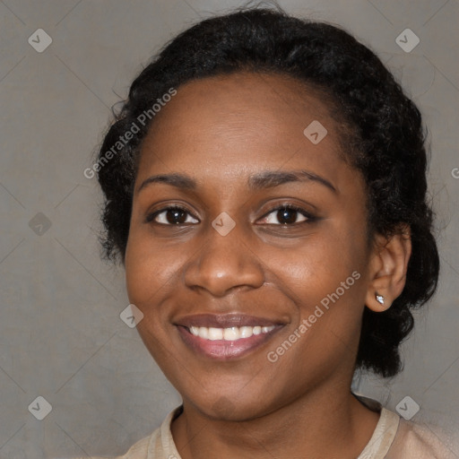 Joyful black young-adult female with long  black hair and brown eyes