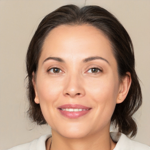 Joyful white adult female with medium  brown hair and brown eyes