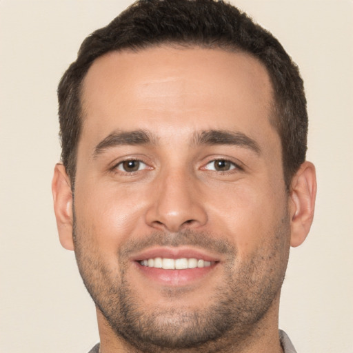 Joyful white young-adult male with short  brown hair and brown eyes