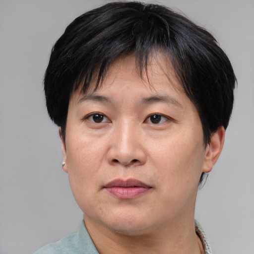 Joyful asian adult female with short  brown hair and brown eyes