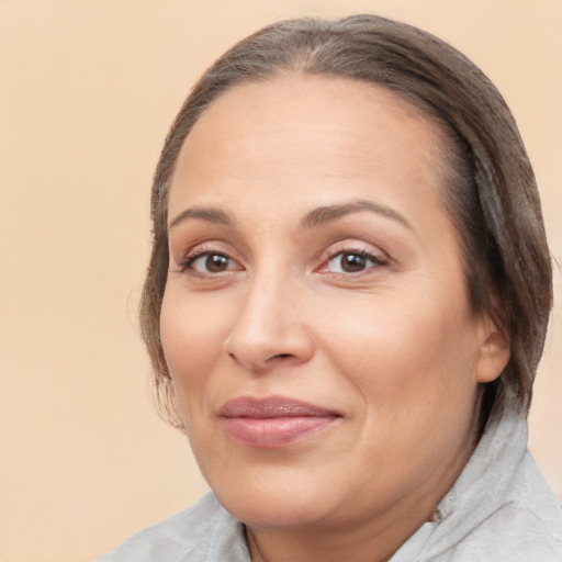 Joyful white adult female with medium  brown hair and brown eyes