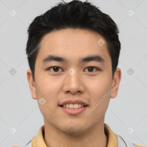 Joyful asian young-adult male with short  brown hair and brown eyes