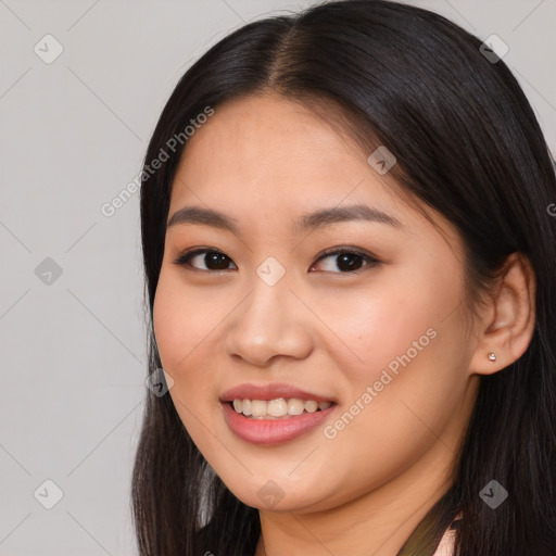 Joyful asian young-adult female with long  brown hair and brown eyes