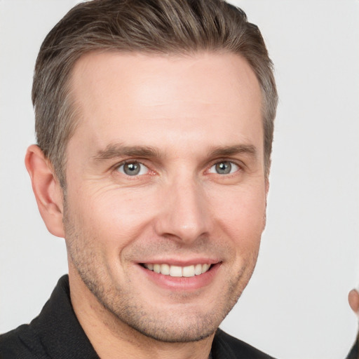 Joyful white adult male with short  brown hair and grey eyes