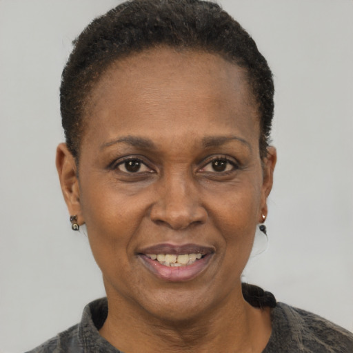 Joyful black adult female with short  brown hair and brown eyes