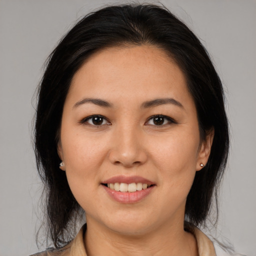 Joyful latino young-adult female with medium  brown hair and brown eyes
