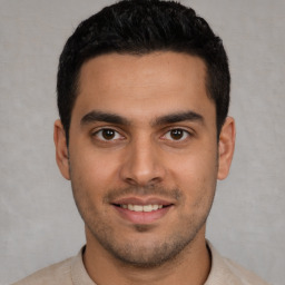 Joyful white young-adult male with short  black hair and brown eyes