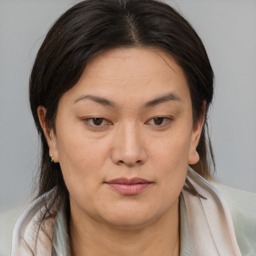 Joyful asian young-adult female with medium  brown hair and brown eyes