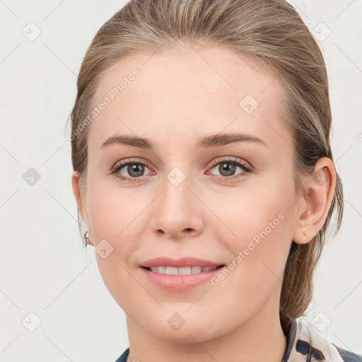 Joyful white young-adult female with medium  brown hair and grey eyes