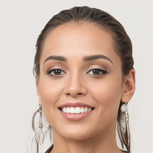 Joyful white young-adult female with long  brown hair and brown eyes