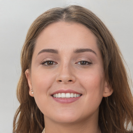 Joyful white young-adult female with long  brown hair and grey eyes