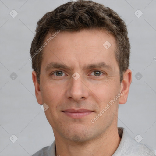 Joyful white adult male with short  brown hair and grey eyes