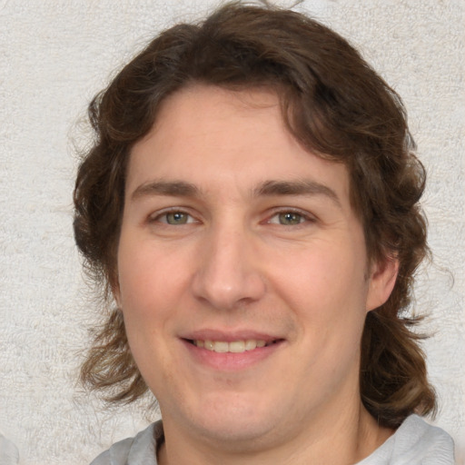 Joyful white adult male with medium  brown hair and brown eyes