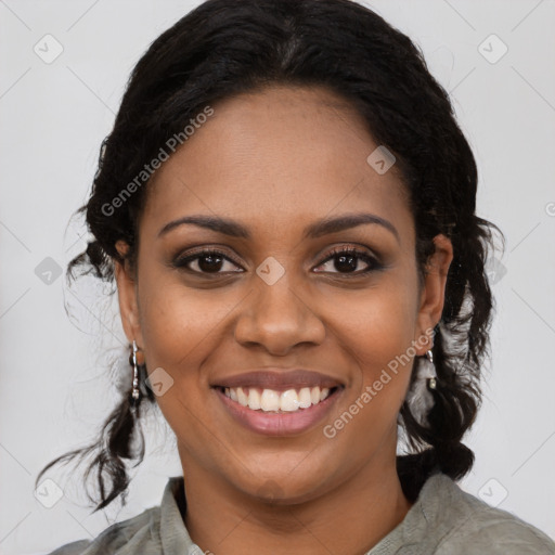 Joyful black young-adult female with long  black hair and brown eyes