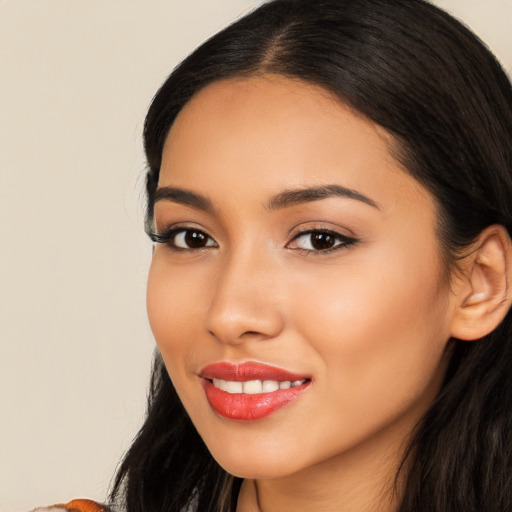 Joyful latino young-adult female with long  brown hair and brown eyes