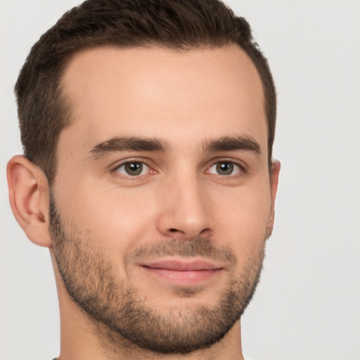 Joyful white young-adult male with short  brown hair and brown eyes