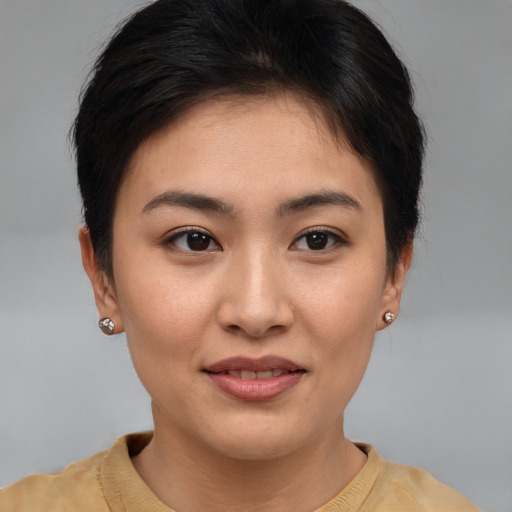 Joyful asian young-adult female with short  brown hair and brown eyes