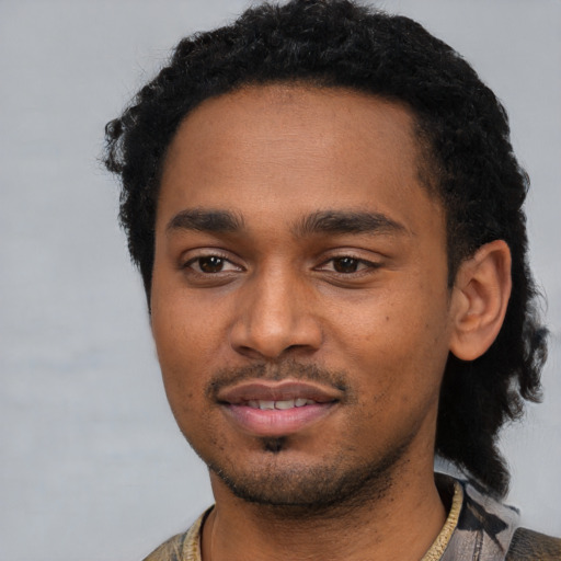 Joyful black young-adult male with short  black hair and brown eyes