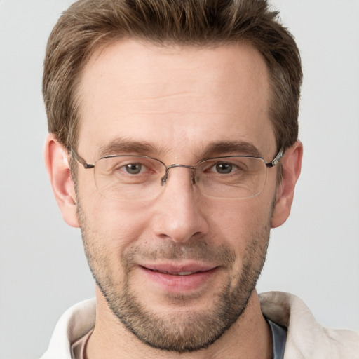 Joyful white adult male with short  brown hair and grey eyes