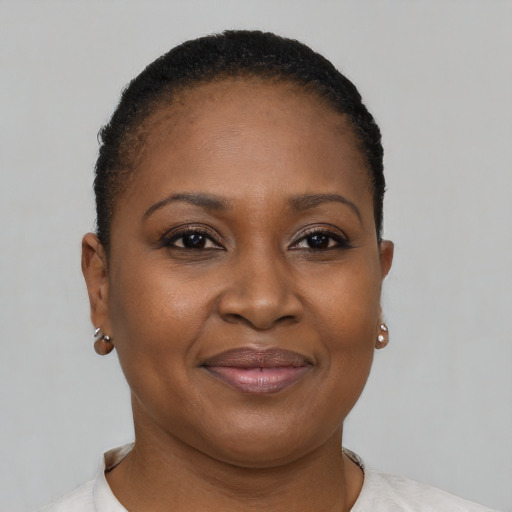 Joyful black adult female with short  brown hair and brown eyes
