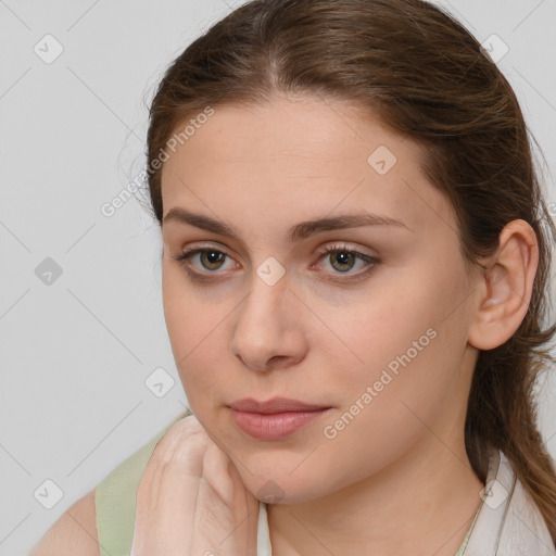 Neutral white young-adult female with long  brown hair and brown eyes