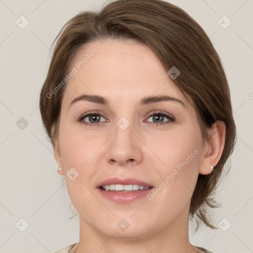 Joyful white young-adult female with medium  brown hair and grey eyes