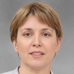 Joyful white adult female with medium  brown hair and grey eyes