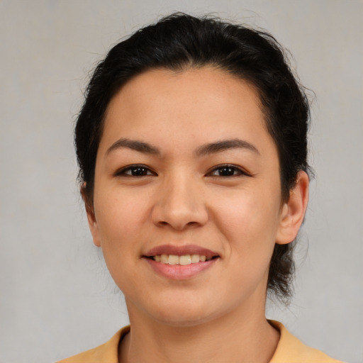 Joyful latino young-adult female with medium  brown hair and brown eyes