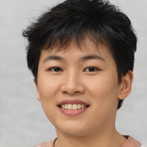 Joyful asian young-adult female with short  brown hair and brown eyes