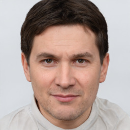 Joyful white adult male with short  brown hair and grey eyes