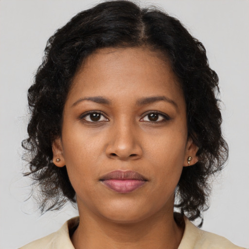 Joyful black young-adult female with medium  brown hair and brown eyes