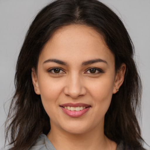 Joyful white young-adult female with long  brown hair and brown eyes