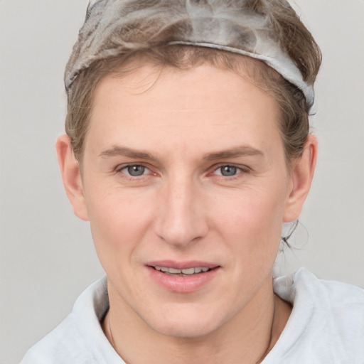 Joyful white adult female with short  brown hair and grey eyes