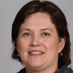 Joyful white adult female with medium  brown hair and brown eyes