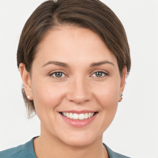 Joyful white young-adult female with short  brown hair and grey eyes