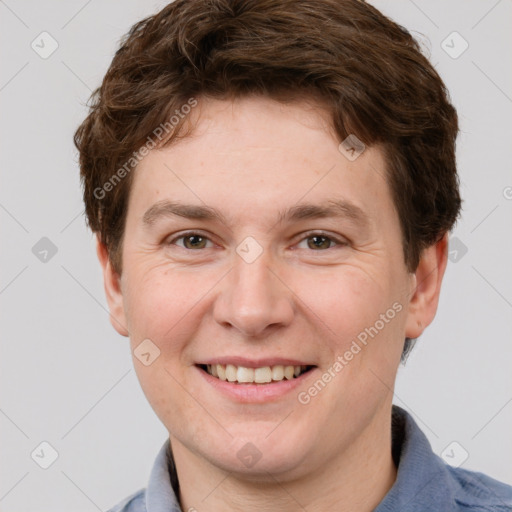 Joyful white adult male with short  brown hair and grey eyes