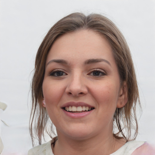 Joyful white young-adult female with medium  brown hair and grey eyes