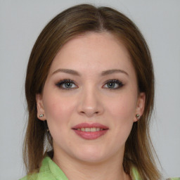 Joyful white young-adult female with medium  brown hair and grey eyes