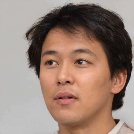 Neutral asian young-adult male with short  brown hair and brown eyes