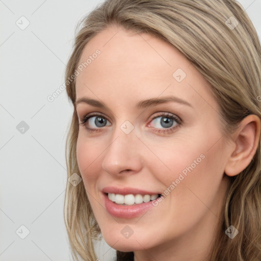 Joyful white young-adult female with long  brown hair and blue eyes