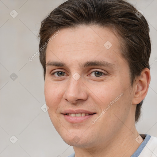 Joyful white adult male with short  brown hair and brown eyes