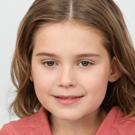 Joyful white child female with medium  brown hair and brown eyes