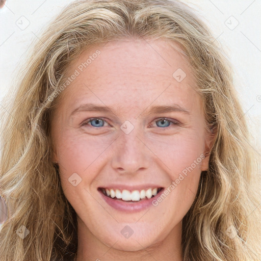 Joyful white young-adult female with long  brown hair and blue eyes