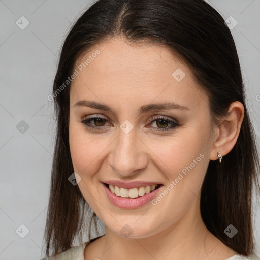 Joyful white young-adult female with long  brown hair and brown eyes