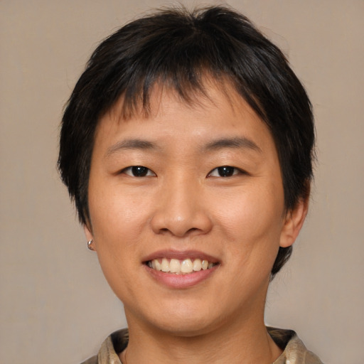 Joyful asian young-adult female with medium  brown hair and brown eyes