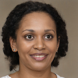 Joyful black adult female with medium  brown hair and brown eyes