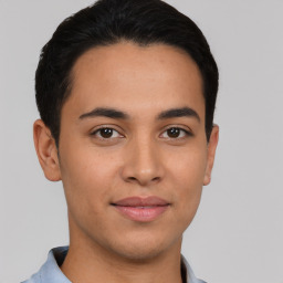 Joyful latino young-adult male with short  brown hair and brown eyes