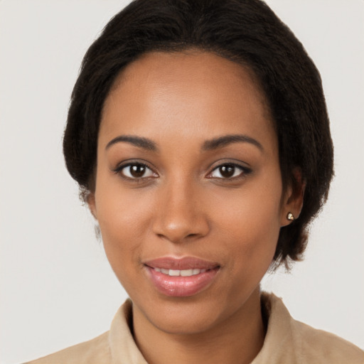 Joyful black young-adult female with medium  brown hair and brown eyes