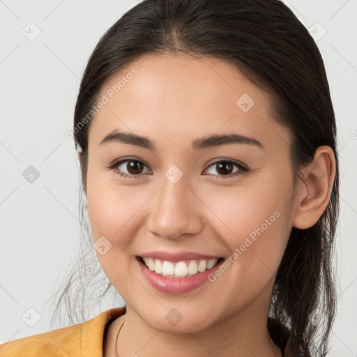 Joyful white young-adult female with long  brown hair and brown eyes