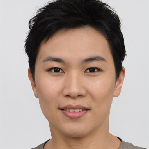 Joyful asian young-adult female with short  black hair and brown eyes